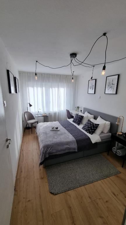a bedroom with a large bed and a desk at Apartman H8 in Bjelovar