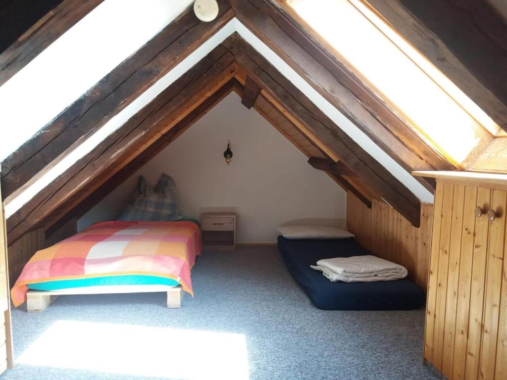 a attic room with a bed and a window at Sophie in Ueckermünde