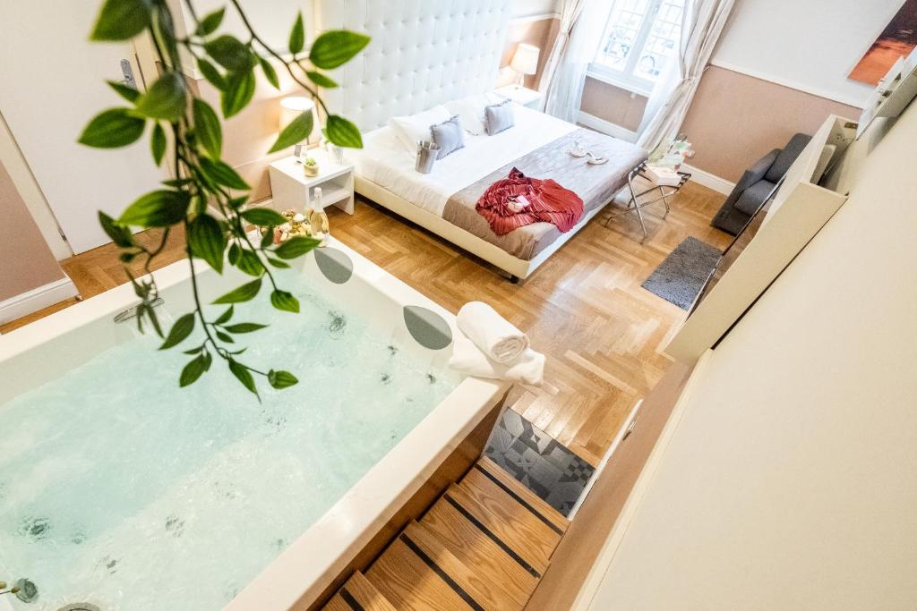 a view of a room with a bathtub and a bedroom at Rome River Inn in Rome