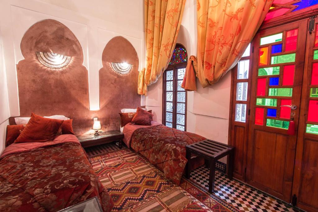 Postel nebo postele na pokoji v ubytování Riad Noujoum Medina