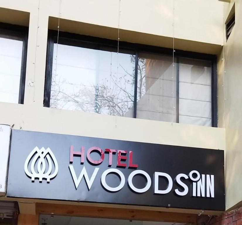 a sign for a hotel woodsimm in front of a building at Hotel Wood Inn in Hoshangābād