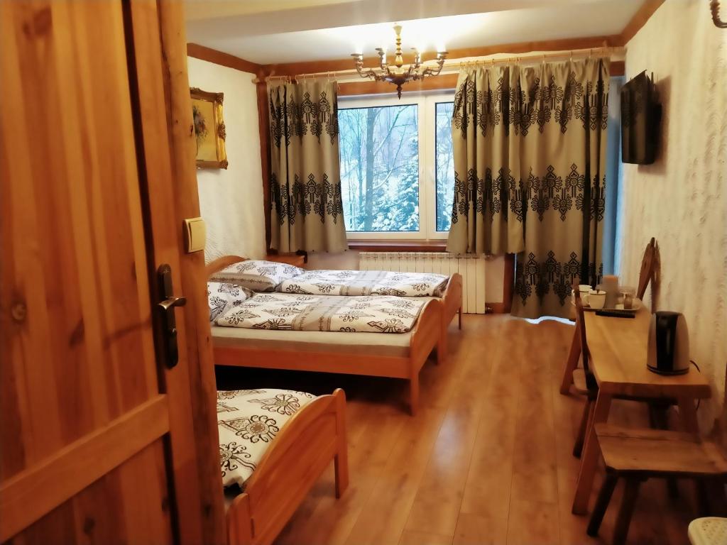 Posteľ alebo postele v izbe v ubytovaní Zajazd Tatrzanski