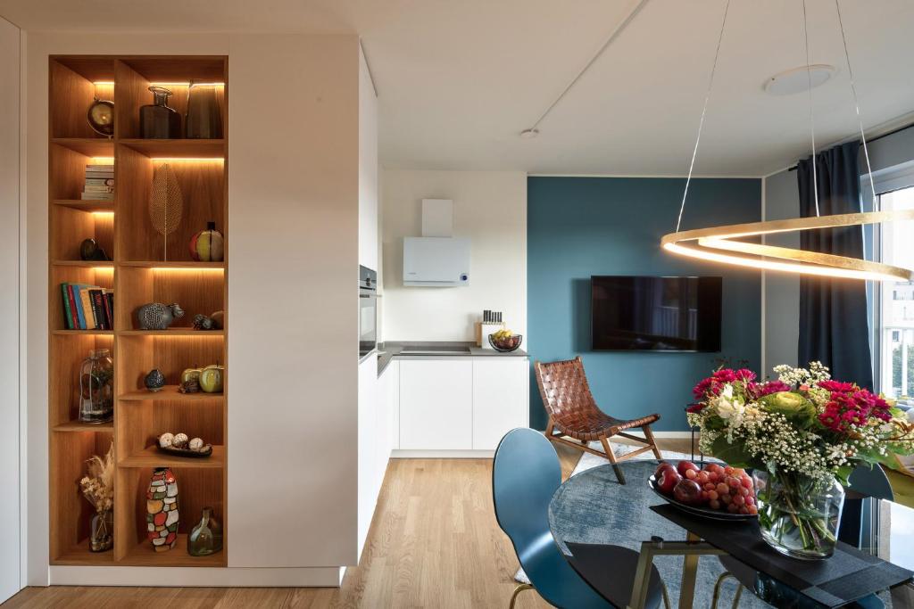 a living room with a table and chairs and a kitchen at SweetHomes Dresden in Dresden