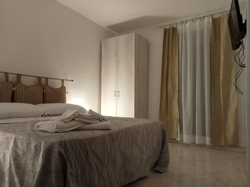a bedroom with a bed with a robe on it at Il Grillo Parlante in Castel Viscardo