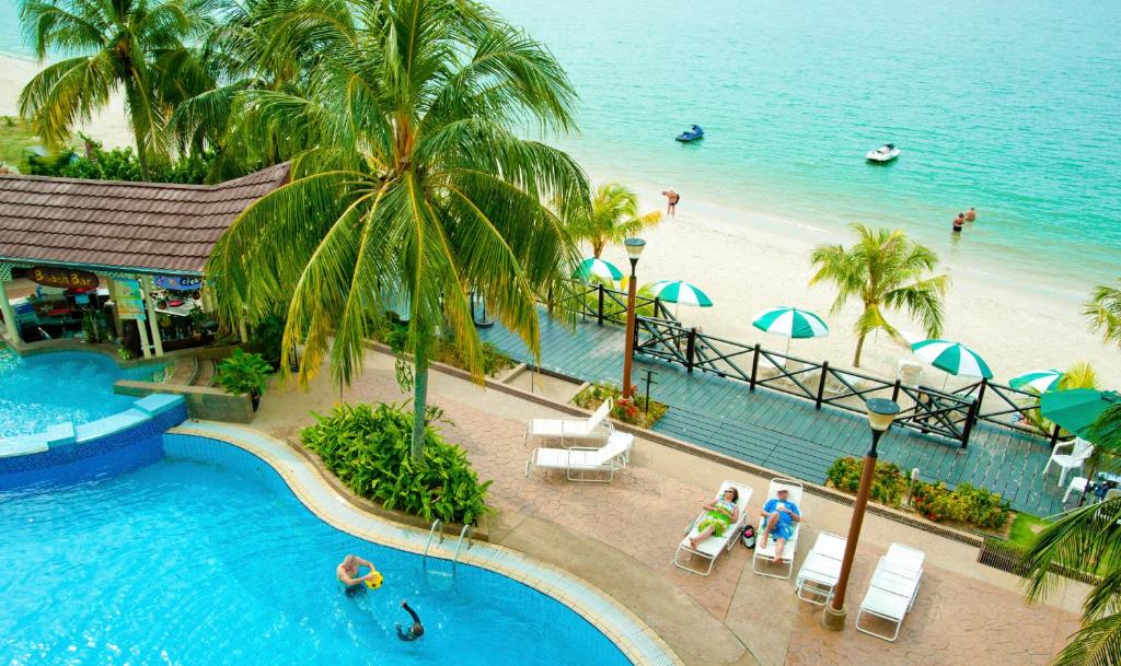 an aerial view of a resort with a swimming pool and a beach at Flamingo Hotel by the Beach, Penang in George Town