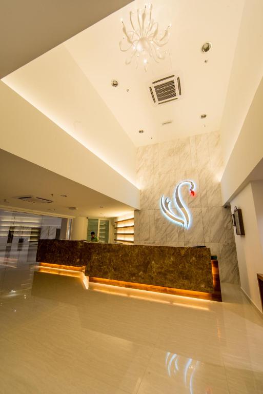 a lobby with a bench and a sign on the wall at Flamingo Hotel by the Beach, Penang in George Town