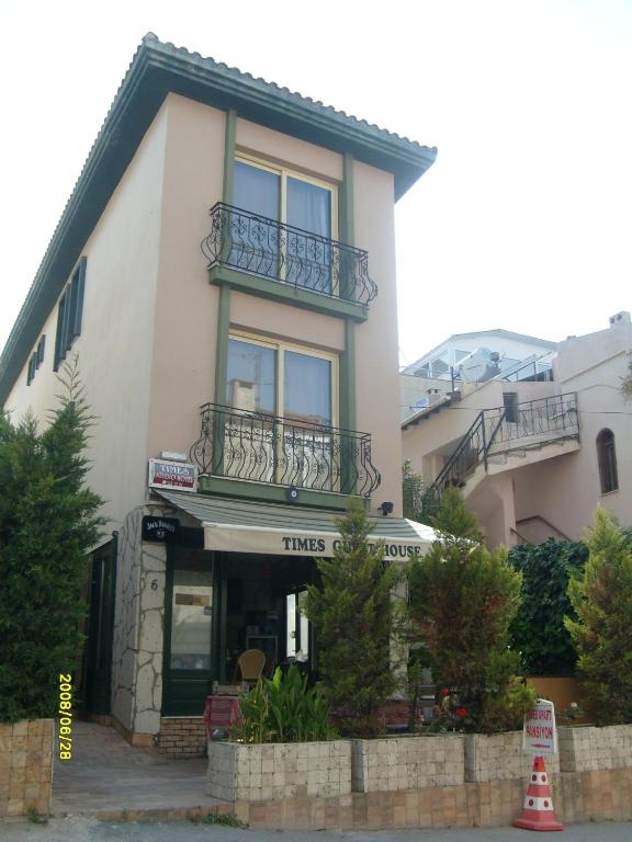 a white building with a balcony on top of it at Times Apart in Çeşme