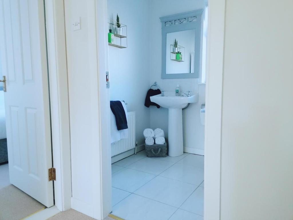 a white bathroom with a sink and a mirror at Castlebar 3 bedroom house in Castlebar