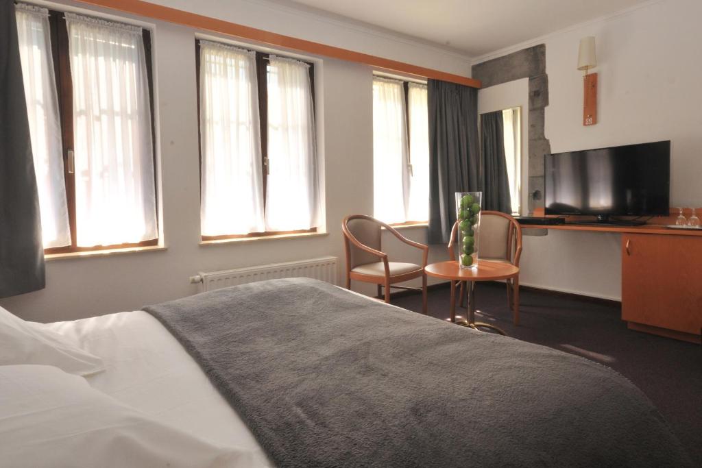 Postel nebo postele na pokoji v ubytování Hôtel du Perron