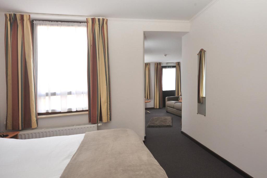 Postel nebo postele na pokoji v ubytování Hôtel du Perron