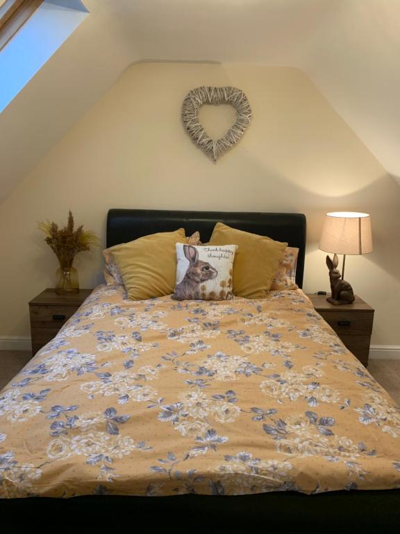 a bedroom with a bed with a heart decoration on the wall at 2 Bedroom duplex apartment in Bawtry