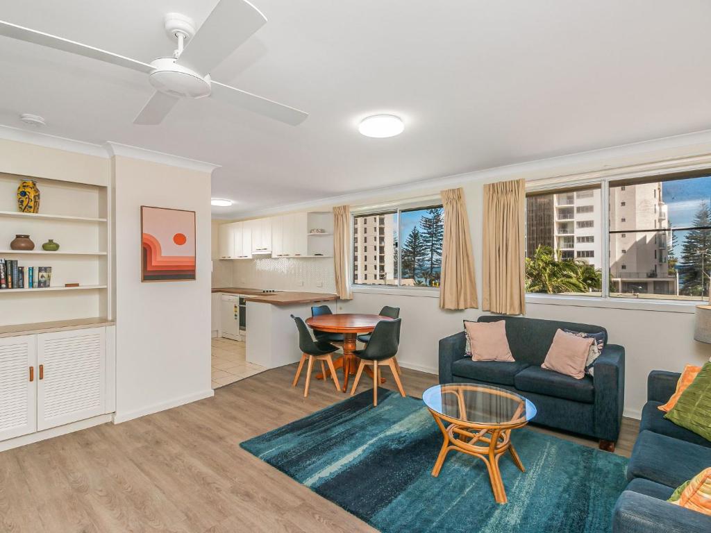 uma sala de estar com um sofá e uma mesa em Como Unit 6 em Gold Coast