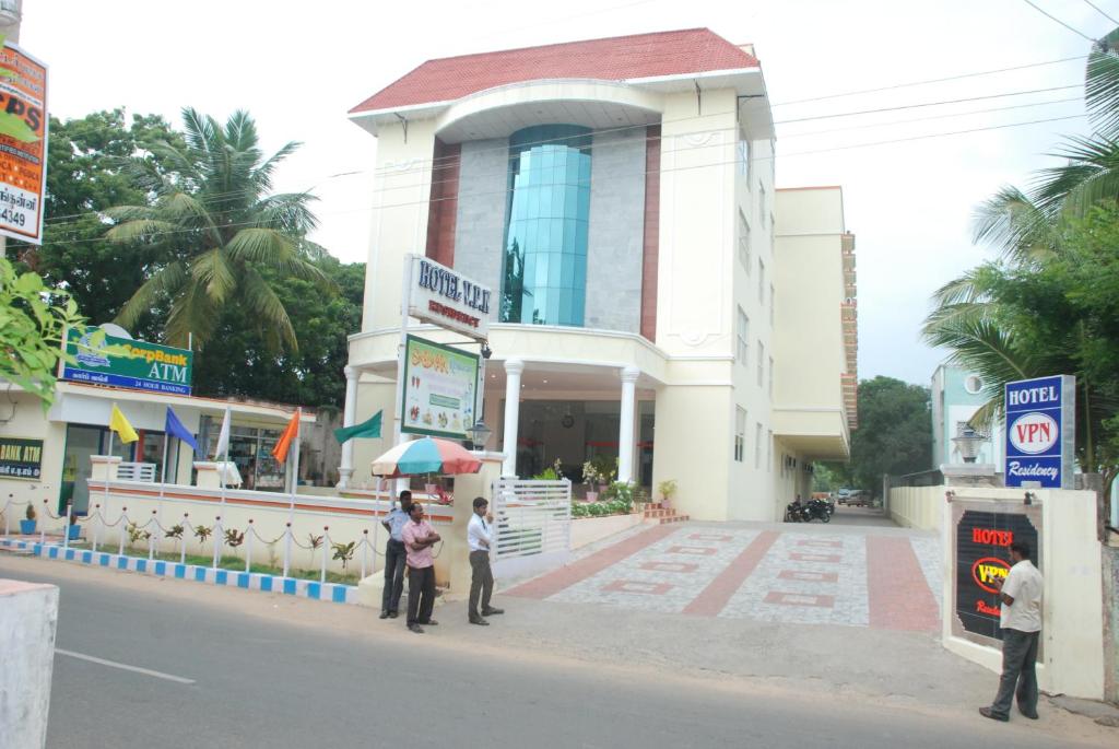 a group of people standing in front of a building at Hotel Vpn Residency in Velankanni