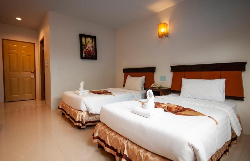 Postel nebo postele na pokoji v ubytování Chiangrai Grand Room Hotel