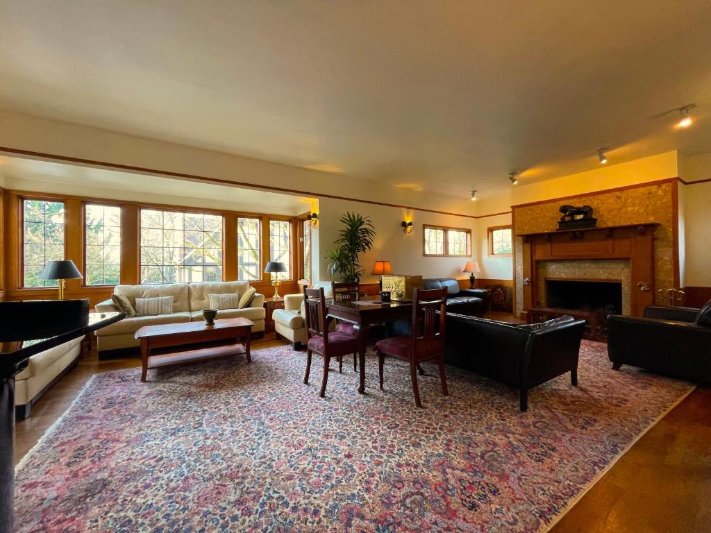a living room with a table and a fireplace at Cecil Bacon Manor in Seattle