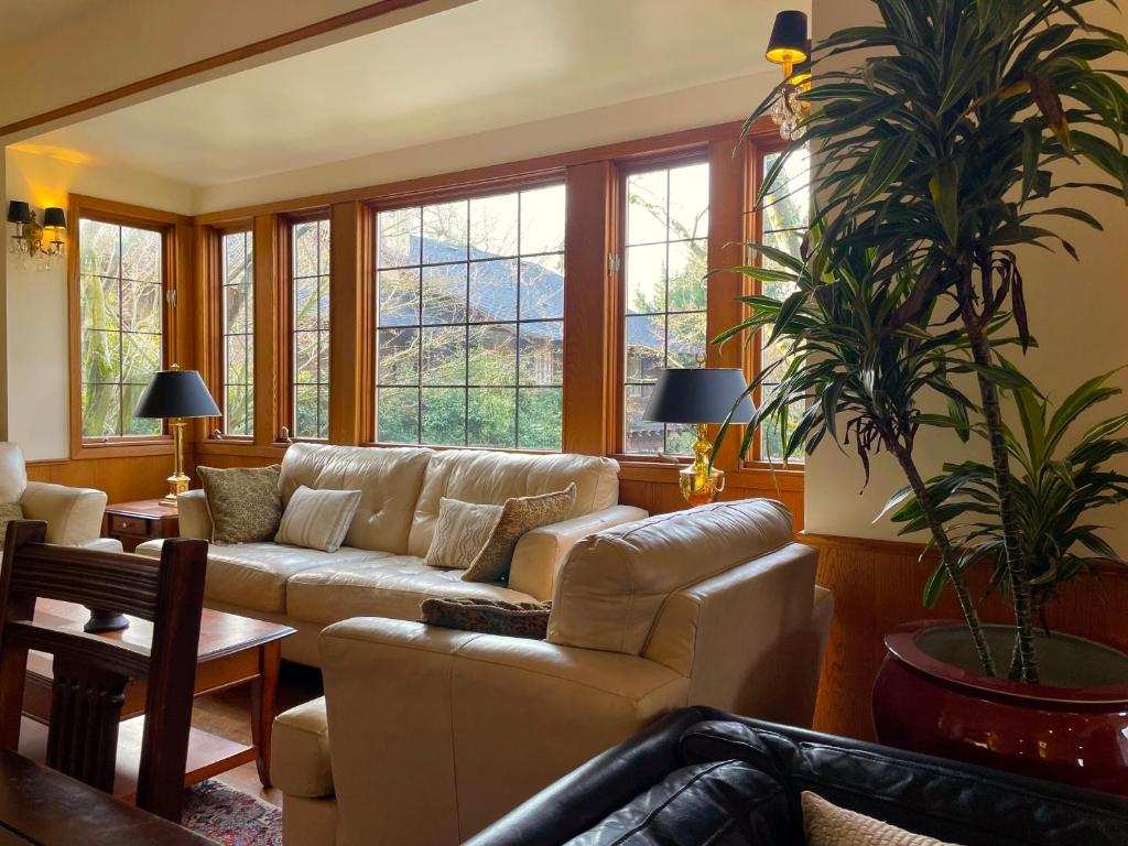 a living room with a couch and a potted plant at Cecil Bacon Manor in Seattle