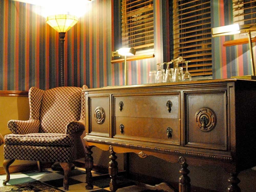 a room with a dresser and a chair and a table at Cecil Bacon Manor in Seattle