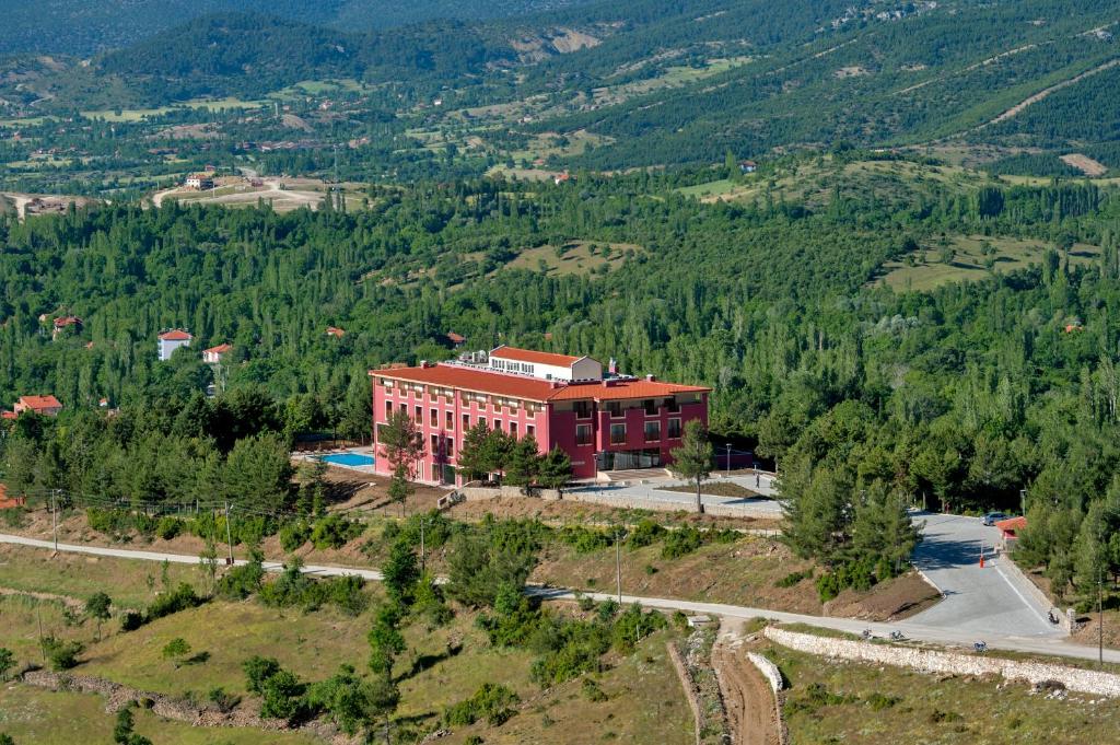 an aerial view of a red building on a mountain at Sagalassos Lodge & Spa Hotel in Ağlasun