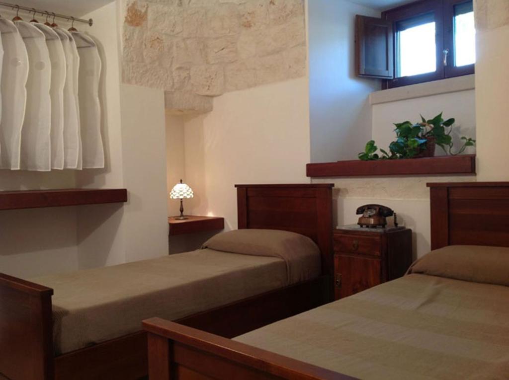Letto o letti in una camera di B&B Via dei Trulli