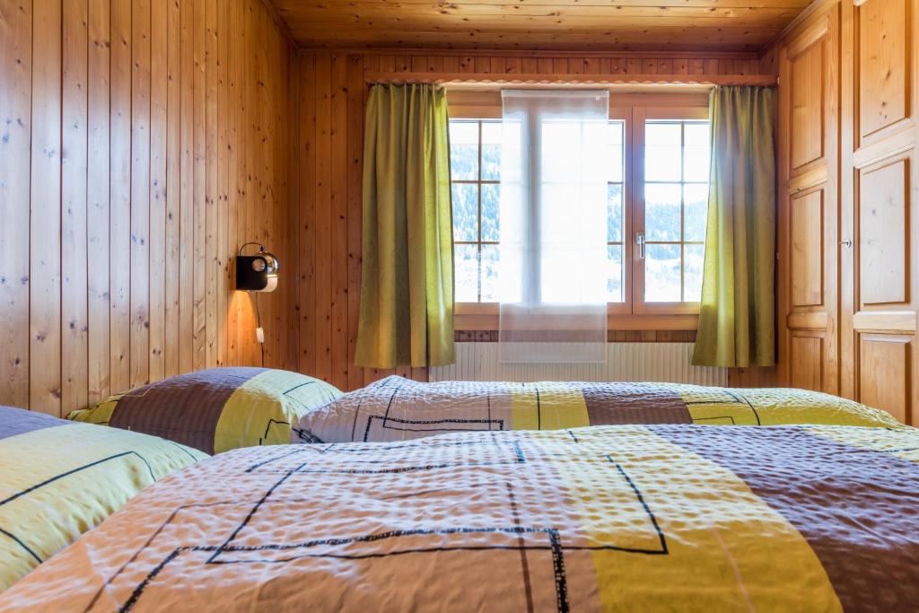 Postel nebo postele na pokoji v ubytování Chalet Sunnegga