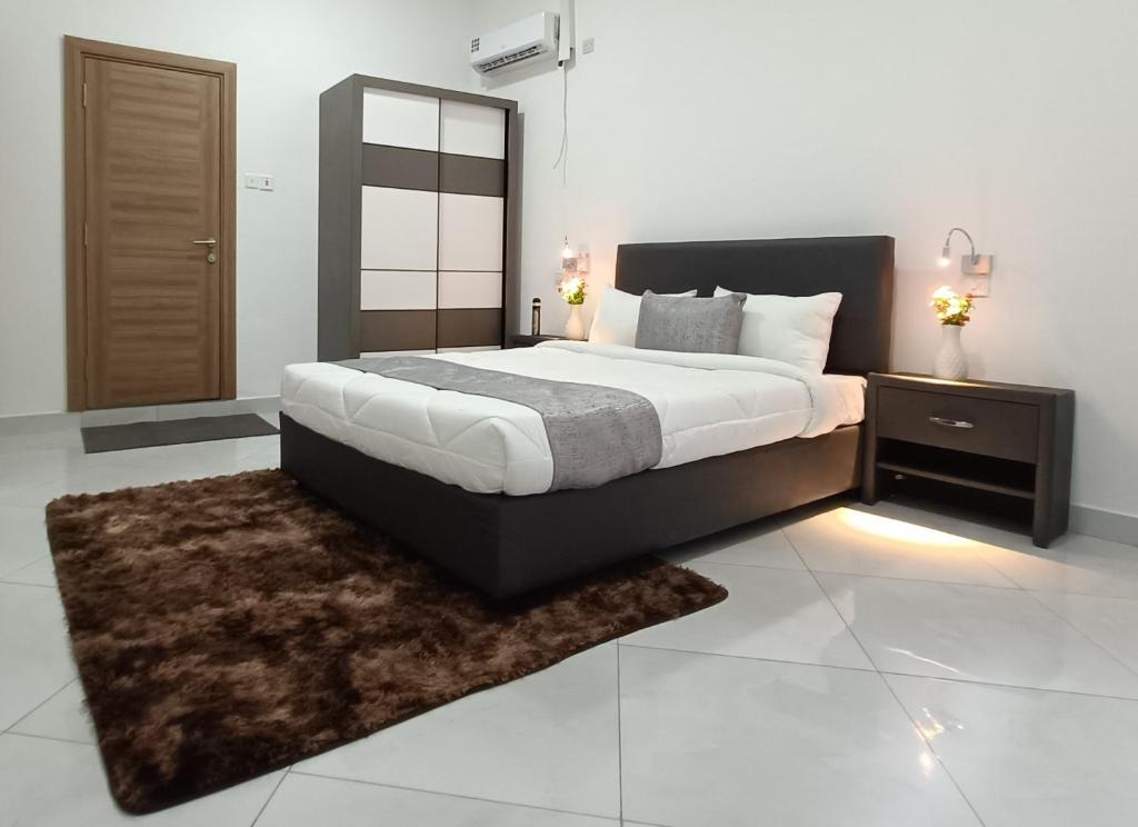 a bedroom with a large bed and a rug at City Centre in Mombasa