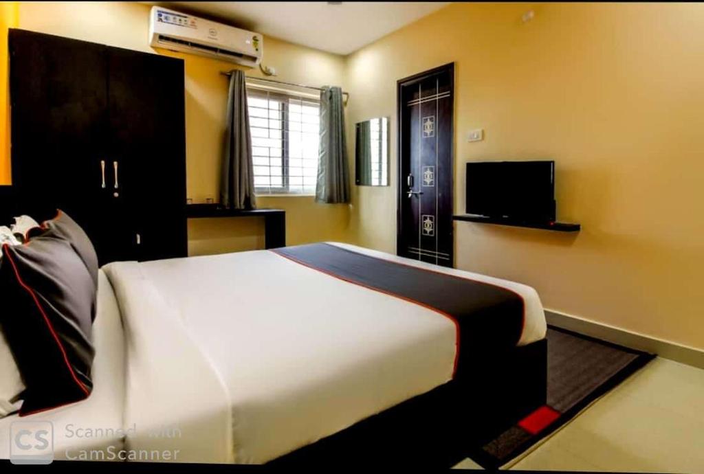 a bedroom with a large bed and a television at HOTEL SRIRAMA EMPIRE in Hyderabad