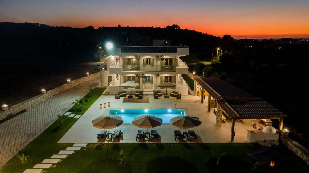 an aerial view of a house with a swimming pool at night at Ktima Kritikos in Paradeísion