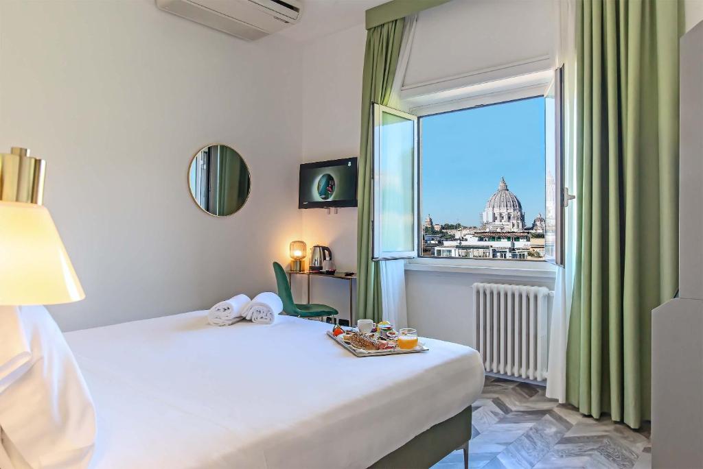 a bedroom with a bed and a large window at Bloom Hotel Rome in Rome