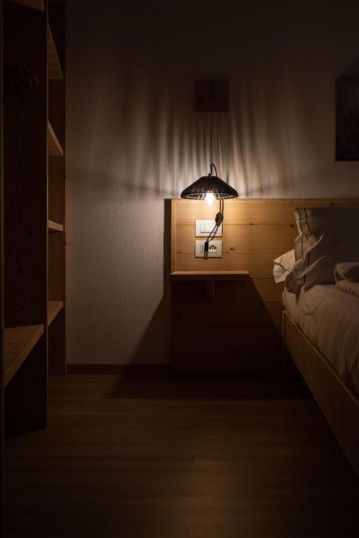 Postel nebo postele na pokoji v ubytování Giallo Dolomiti Wellness