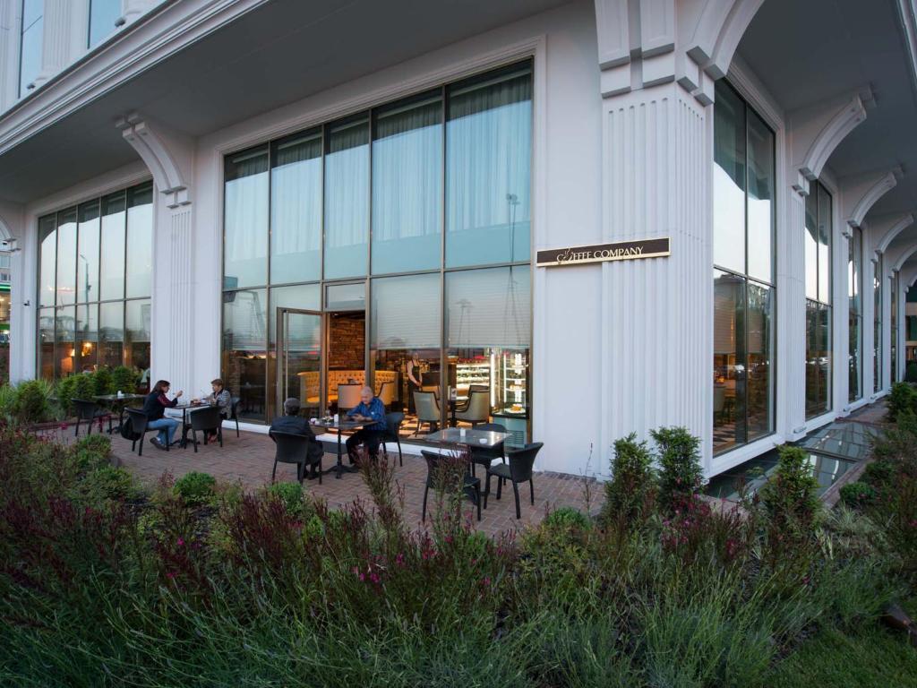 a group of people sitting at tables outside of a building at Elite World Istanbul Florya in Istanbul