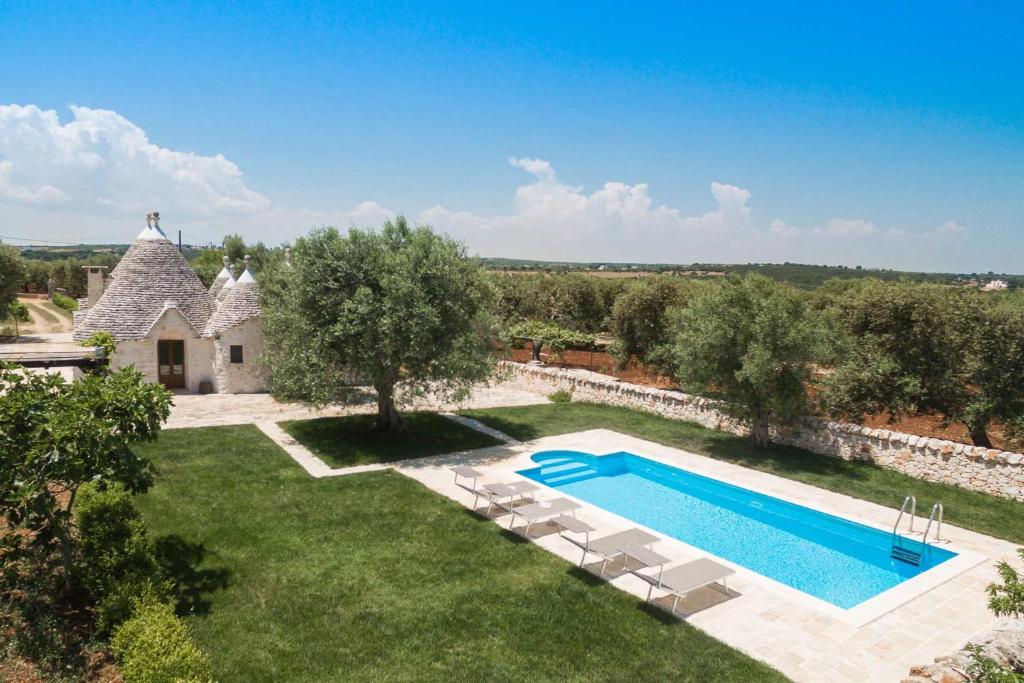 an external view of a villa with a swimming pool at Trullo Due Ulivi in Monopoli