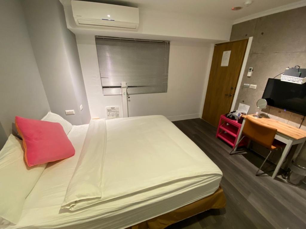 Postel nebo postele na pokoji v ubytování M Taipei Hotel