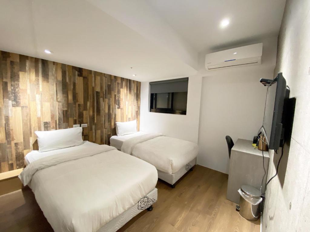 Postel nebo postele na pokoji v ubytování M Taipei Hotel