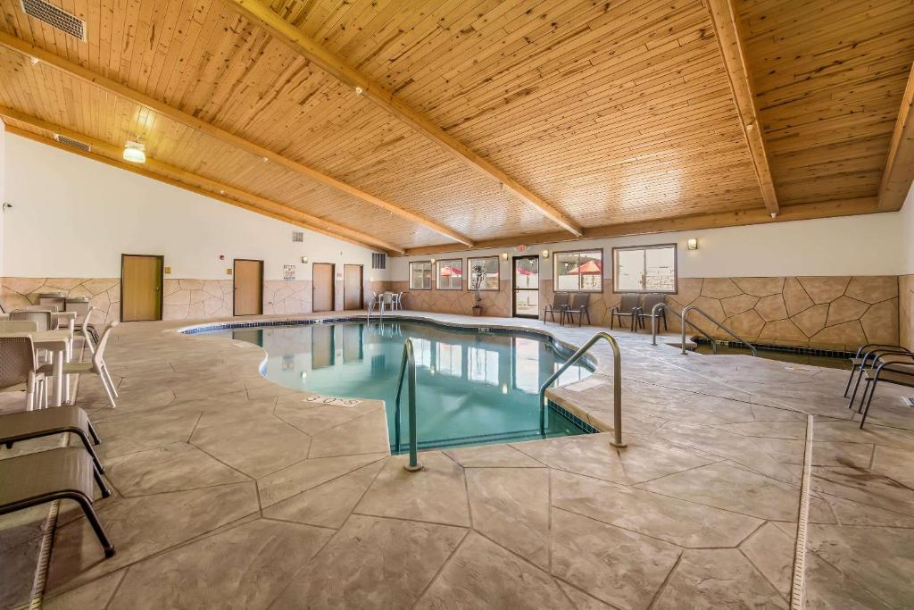 a pool in a large room with a wooden ceiling at Econo Lodge in Rice Lake