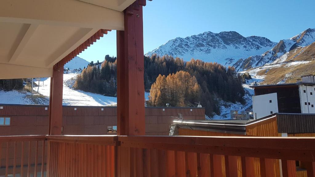 a balcony with a view of a snow covered mountain at Plagne centre -Pied de pistes in La Plagne Tarentaise