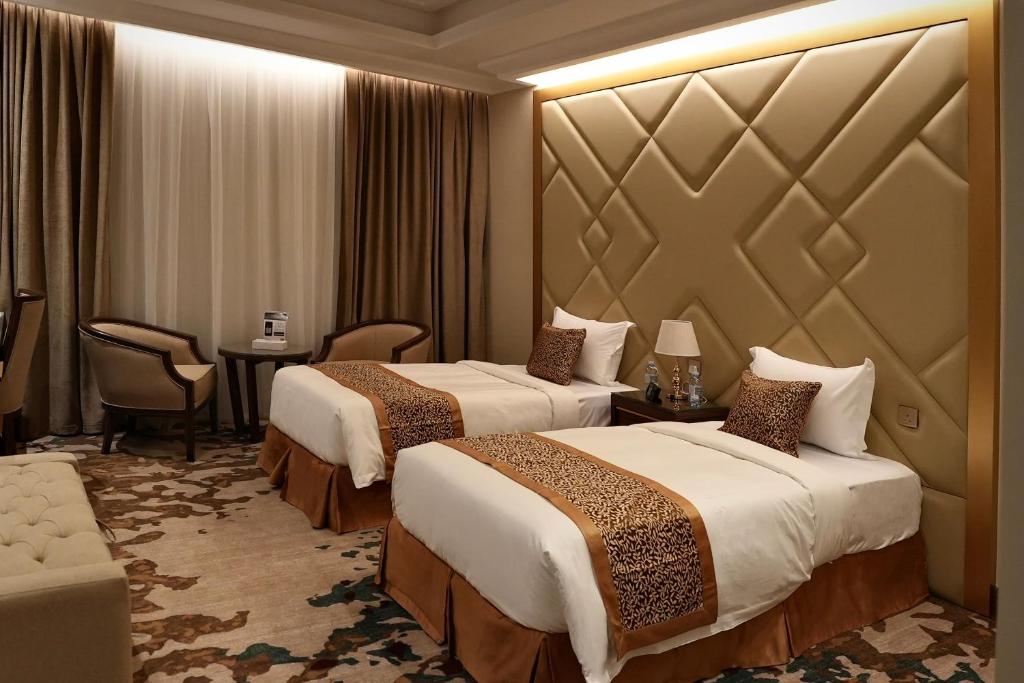 Giường trong phòng chung tại Temandra Hotel