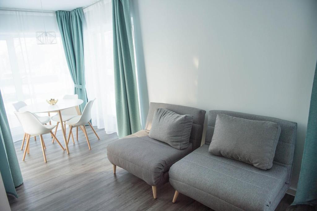 a living room with a couch and a table at J55 Apartments in Riga