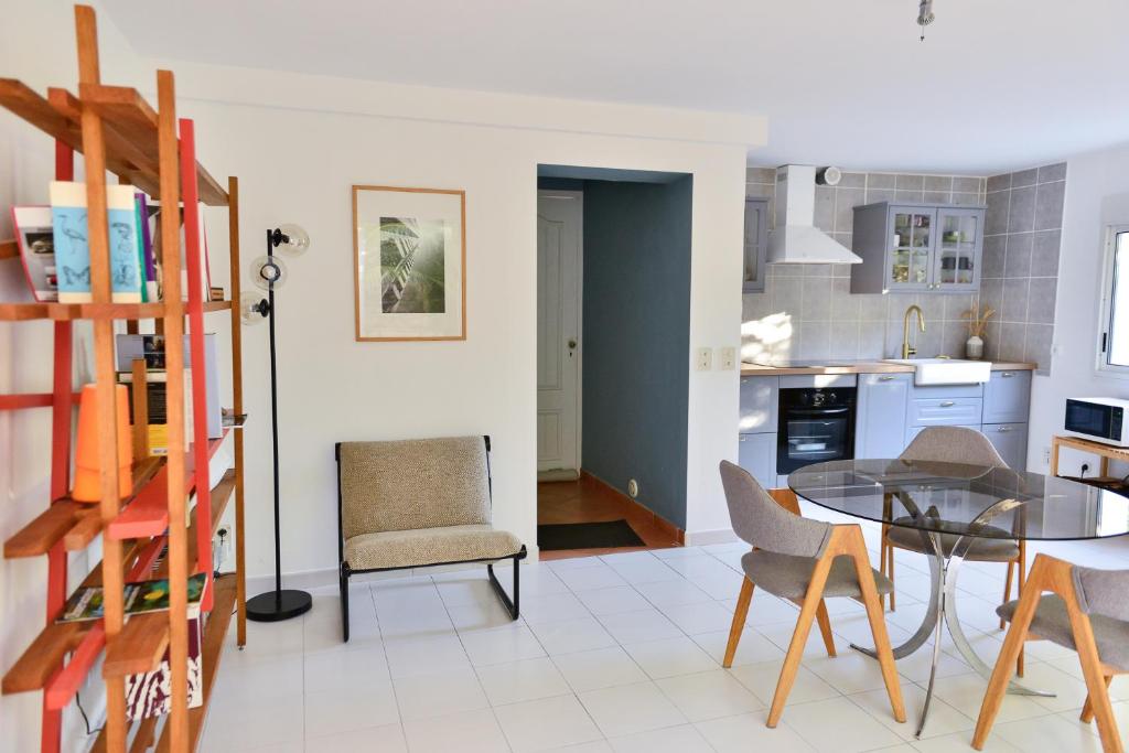 a kitchen and dining room with a table and chairs at L’appartement - Jardin Secret in Marseille