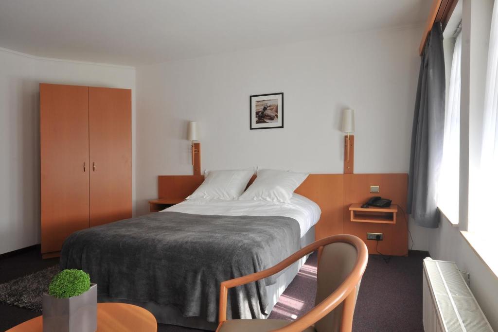 Postel nebo postele na pokoji v ubytování Hôtel du Perron
