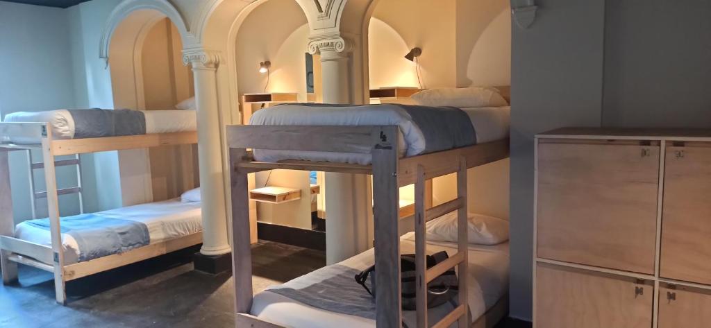 a room with three bunk beds in a room at Hostel Boutique Merced 88 in Santiago