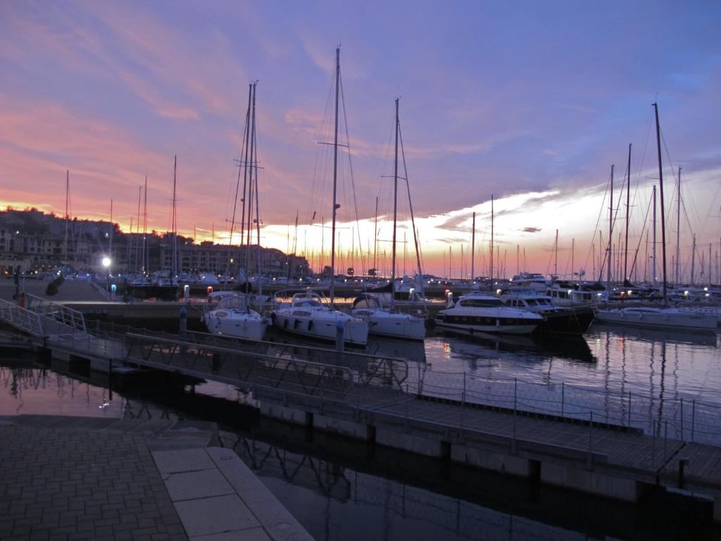 a group of boats docked in a marina at sunset at Hotel San Rocco in Muggia