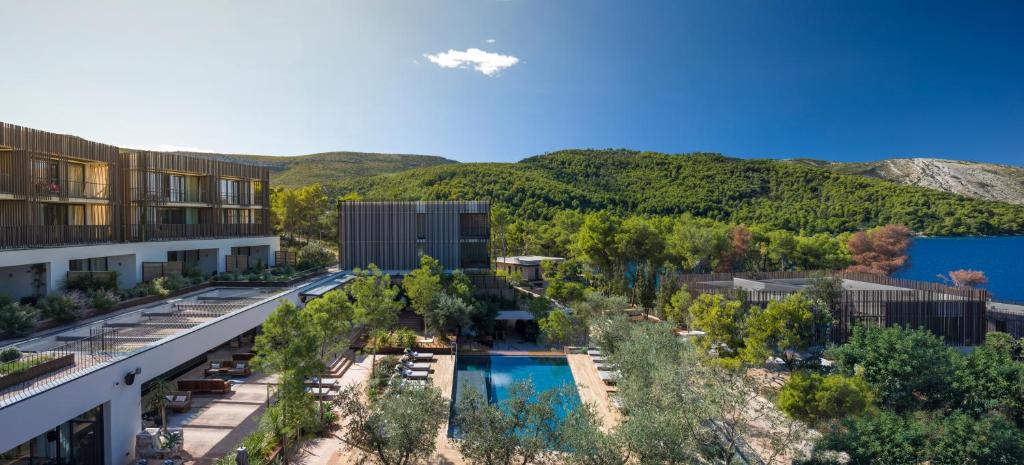 an aerial view of a resort with a pool and trees at Maslina Resort in Stari Grad