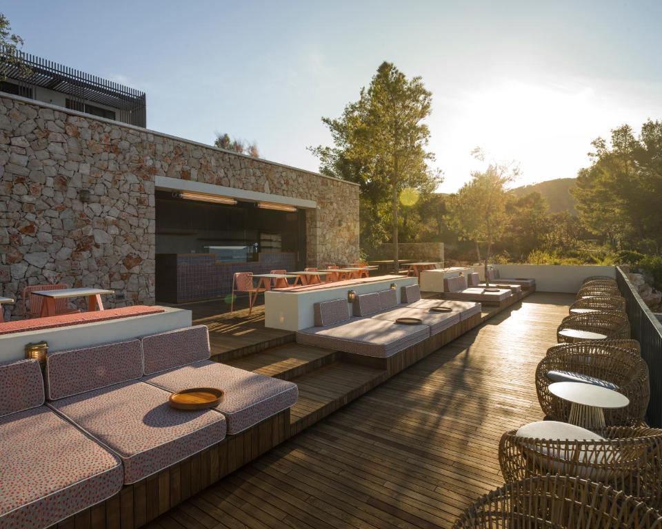a group of tables and chairs on a patio at Maslina Resort in Stari Grad