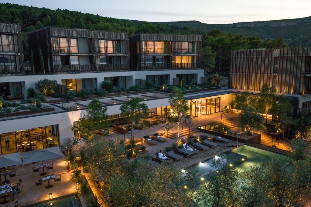 an aerial view of a building with a pool at Maslina Resort in Stari Grad