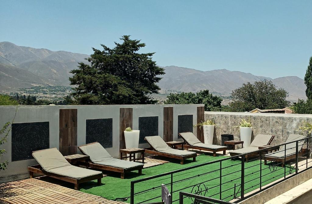 a group of chairs and tables on a patio at Hotel Colonial Tafi del Valle by DOT Tradition in Tafí del Valle