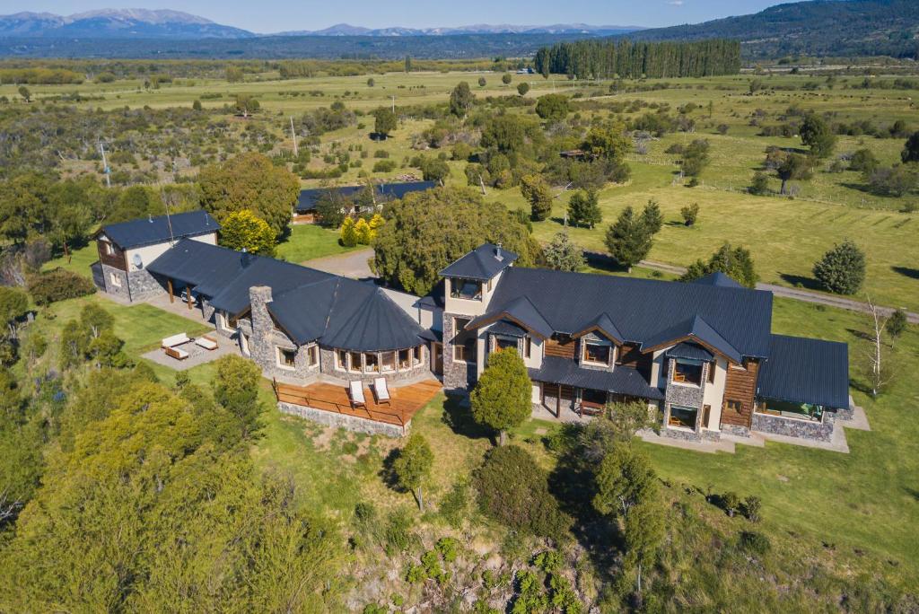 an aerial view of a large house on a hill at Challhuaquen Lodge in Trevelin