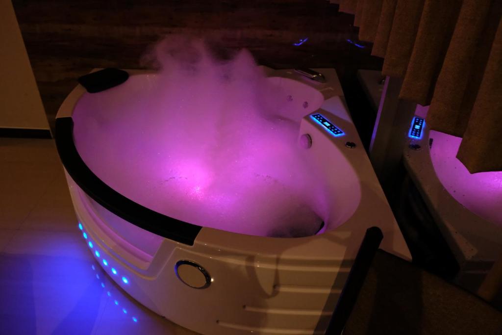 a purple bathtub with smoke coming out of it at Hotel Puma'r Tacna in Tacna