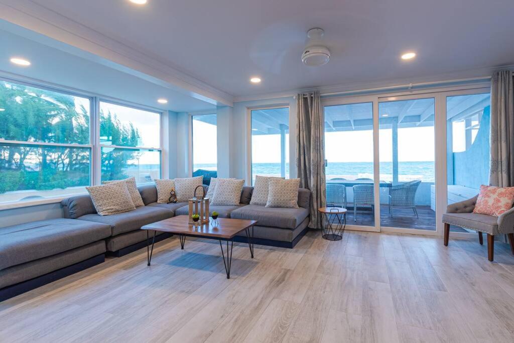 a living room with a couch and a table at Harbour Mews - Oceanfront Townhouse in Nassau