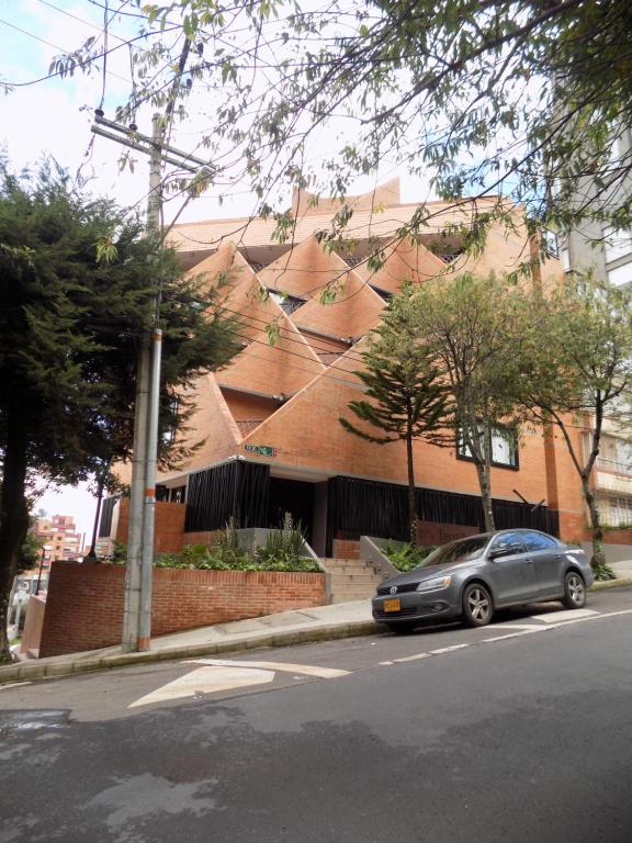 a car parked in front of a brick building at Terrazas in Bogotá