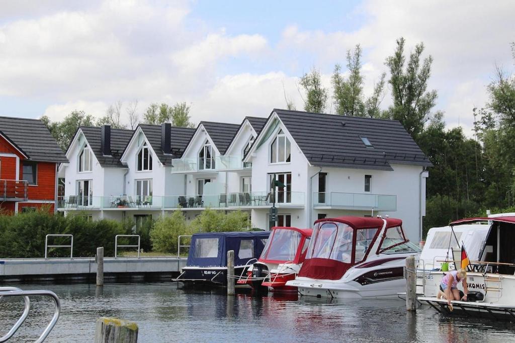 a group of houses with boats docked in the water at Apartment Hafenflair am Plauer See, Plau am See in Plau am See